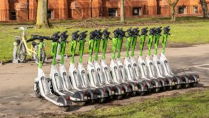 E scooters lined up by the side of a path